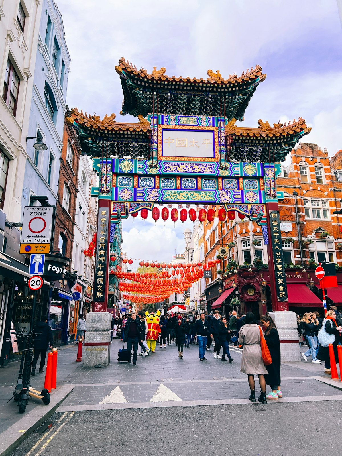 The colourful Chinatown gateway on a busy street in London